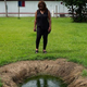Catherine Flowers examines an overflowing septic tank in Lowndes County, Ala.